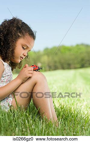 Girl with a toy ladybird View Large Photo Image Stock Image - Girl with a toy ladybird. Fotosearch
