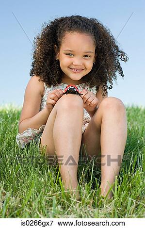 Stock Photo - Girl with a toy ladybird. Fotosearch