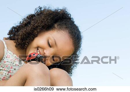 Stock Photo - Girl with a toy ladybird. Fotosearch