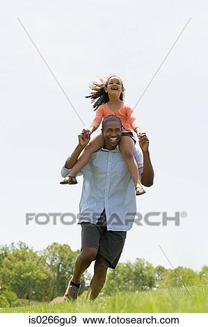 Stock Photo - Man carrying daughter. Fotosearch
