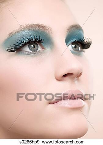 Stock Photo - A young woman wearing false eyelashes. Fotosearch