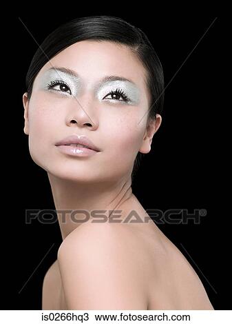 Stock Image - A young woman wearing silver eyeshadow. Fotosearch