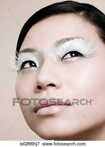 A young woman wearing white false eyelashes View Large Photo Image Stock Photo - A young woman wearing white false eyelashes. Fotosearch