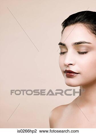 A young woman with her eyes closed View Large Photo Image Stock Image - A young woman with her eyes closed. Fotosearch