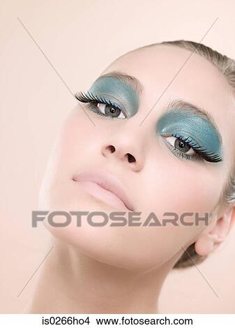 Picture - Portrait of a young woman wearing false eyelashes. Fotosearch