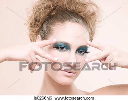 Portrait of a young woman wearing false eyelashes View Large Photo Image Stock Photograph - Portrait of a young woman wearing false eyelashes. Fotosearch