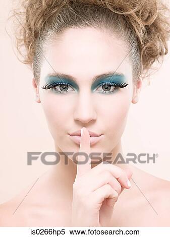 Stock Photography - Portrait of a young woman wearing false eyelashes. Fotosearch