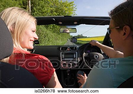 A couple driving View Large Photo Image Stock Photo - A couple driving. Fotosearch