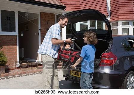 A father and son lifting a bag out of a boot View Large Photo Image Stock Image - A father and son lifting a bag out of a boot. Fotosearch