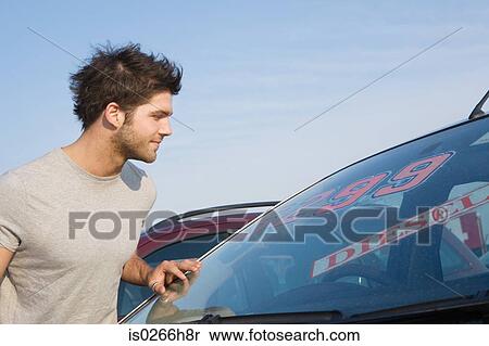 A man looking at a car View Large Photo Image Stock Photography - A man looking at a car. Fotosearch