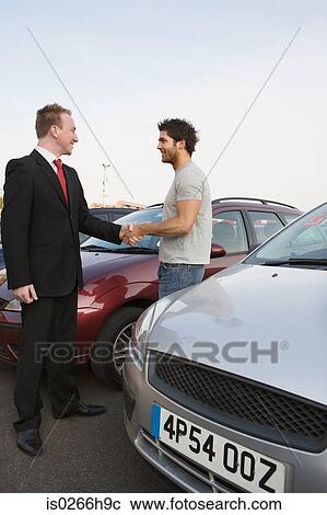 A man shaking hands with a salesman View Large Photo Image Stock Image - A man shaking hands with a salesman. Fotosearch