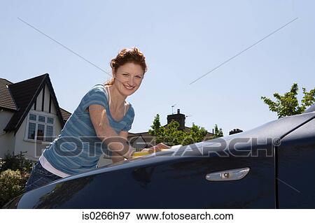 A woman washing a car View Large Photo Image Stock Photo - A woman washing a car. Fotosearch