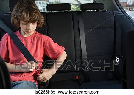 Stock Photography - Boy fastening his seatbelt. Fotosearch