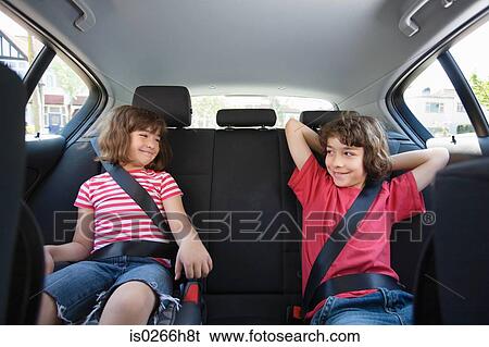 Stock Photograph - Children sat in a car. Fotosearch