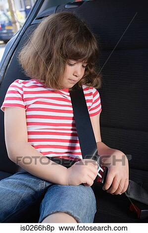 Stock Photography - Girl fastening his seatbelt. Fotosearch