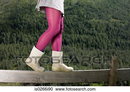 Girl walking on a wooden fence View Large Photo Image Stock Image - Girl walking on a wooden fence. Fotosearch