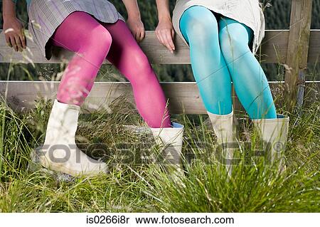 Girls wearing tights sitting on a fence View Large Photo Image Stock Photography - Girls wearing tights sitting on a fence. Fotosearch