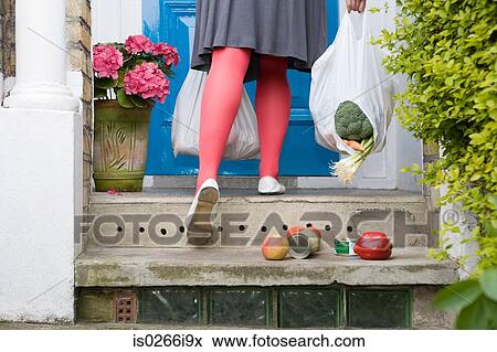 Shopping falling from a torn bag View Large Photo Image Stock Photo - Shopping falling from a torn bag. Fotosearch