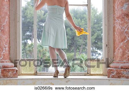 Stock Photograph - Woman cleaning her windows. Fotosearch