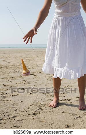 Woman dropping her ice cream on beach View Large Photo Image Stock Image - Woman dropping her ice cream on beach. Fotosearch