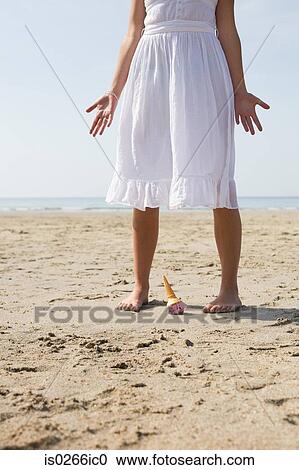 Woman dropping her ice cream on beach View Large Photo Image Stock Image - Woman dropping her ice cream on beach. Fotosearch