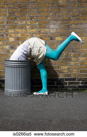 Woman looking in a dustbin View Large Photo Image Stock Photography - Woman looking in a dustbin. Fotosearch