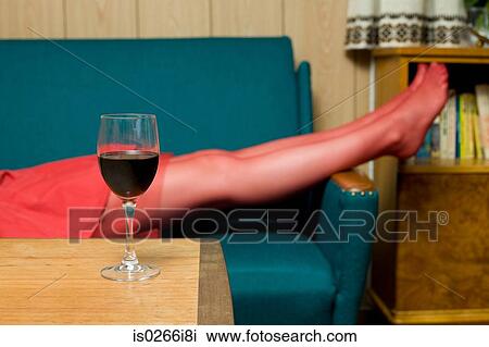 Stock Image - Woman lying on a sofa. Fotosearch