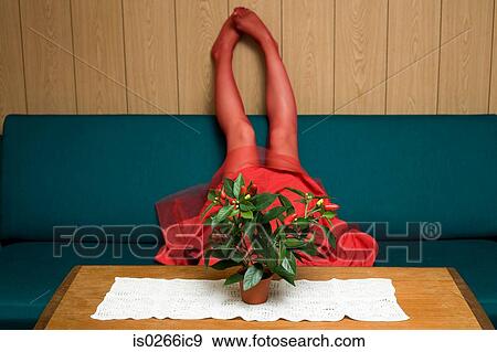 Woman lying upside down on a sofa View Large Photo Image Stock Photo - Woman lying upside down on a sofa. Fotosearch