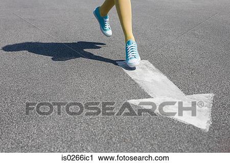 Woman running on a direction arrow View Large Photo Image Stock Image - Woman running on a direction arrow. Fotosearch