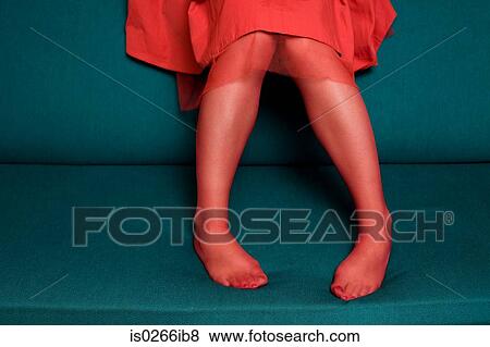 Woman sitting on a sofa View Large Photo Image Stock Photo - Woman sitting on a sofa. Fotosearch