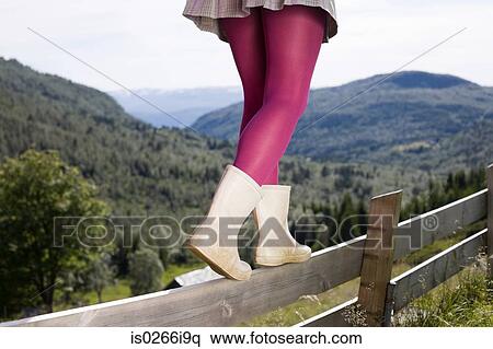Young woman balancing on a wooden fence View Large Photo Image Stock Photography - Young woman balancing on a wooden fence. Fotosearch