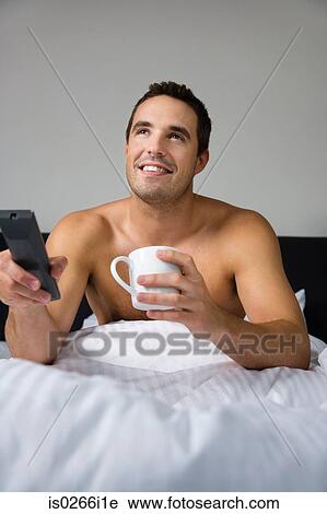 Stock Image - A man watching tv. Fotosearch