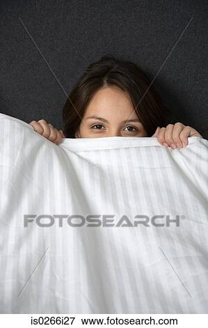 A woman hiding under a duvet View Large Photo Image Stock Photo - A woman hiding under a duvet. Fotosearch