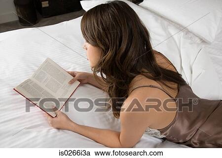 A woman reading a book View Large Photo Image Stock Image - A woman reading a book. Fotosearch