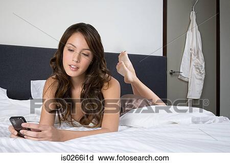 A woman using a cell phone View Large Photo Image Stock Image - A woman using a cell phone. Fotosearch