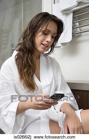 A woman using a cell phone View Large Photo Image Stock Image - A woman using a cell phone. Fotosearch
