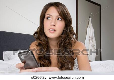 A woman using a cell phone View Large Photo Image Stock Photo - A woman using a cell phone. Fotosearch