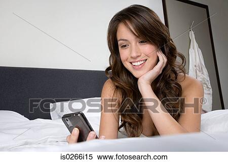 A woman using a cell phone View Large Photo Image Stock Photography - A woman using a cell phone. Fotosearch