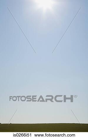 Stock Image - Sun over field. Fotosearch