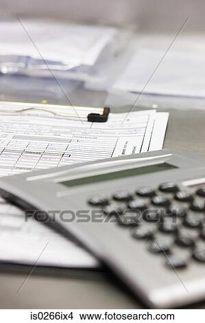 Calculator and document View Large Photo Image Picture - Calculator and document. Fotosearch