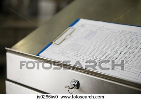 Clipboard on a filing cabinet View Large Photo Image Stock Image - Clipboard on a filing cabinet. Fotosearch