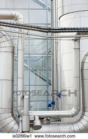 Stock Image - Industrial piping outside a factory. Fotosearch