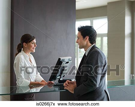 A businessman and a receptionist View Large Photo Image Stock Photo - A businessman and a receptionist. Fotosearch