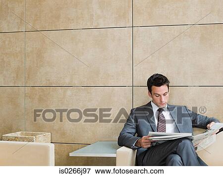 A businessman reading a newspaper View Large Photo Image Stock Photo - A businessman reading a newspaper. Fotosearch
