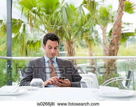 A businessman using a cell phone View Large Photo Image Stock Image - A businessman using a cell phone. Fotosearch