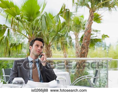 Stock Photo - A businessman using a cell phone. Fotosearch