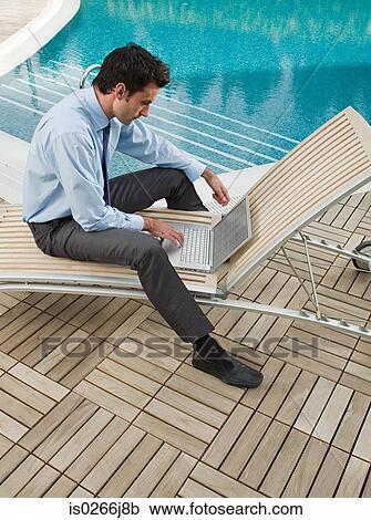 A businessman using a laptop View Large Photo Image Stock Image - A businessman using a laptop. Fotosearch
