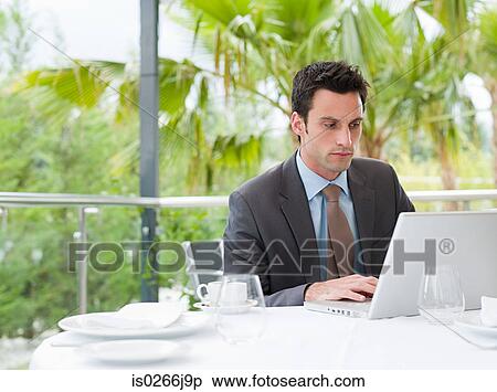 A businessman using a laptop View Large Photo Image Stock Photography - A businessman using a laptop. Fotosearch