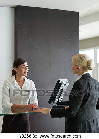A businesswoman and a receptionist View Large Photo Image Stock Photography - A businesswoman and a receptionist. Fotosearch