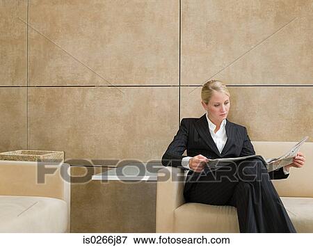 A businesswoman reading a newspaper View Large Photo Image Stock Photo - A businesswoman reading a newspaper. Fotosearch